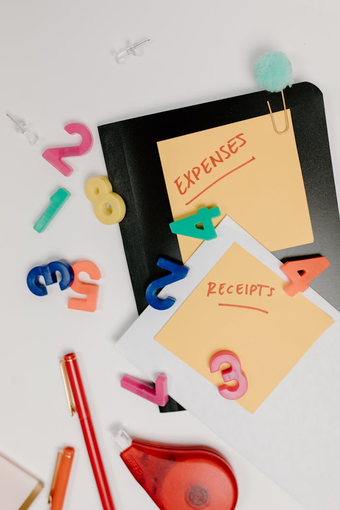 About Flat lay of colorful office supplies and sticky notes labeled 'Expenses' and 'Receipts'.